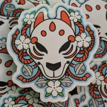 Enchanting Kitsune Mask Sticker: Japanese Fox Folklore Art with Intricate Detailing and Cultural Charm